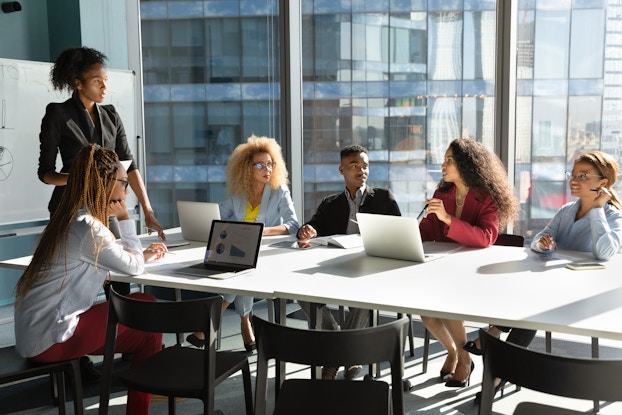 Group of business people hold a meeting in a sunny office