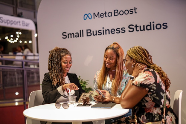  Three small business owners sitting at a table during a Meta Small Business Studios event.