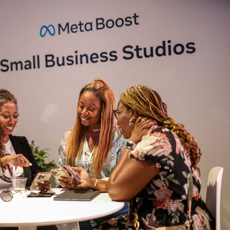 Three small business owners sitting at a table during a Meta Small Business Studios event.