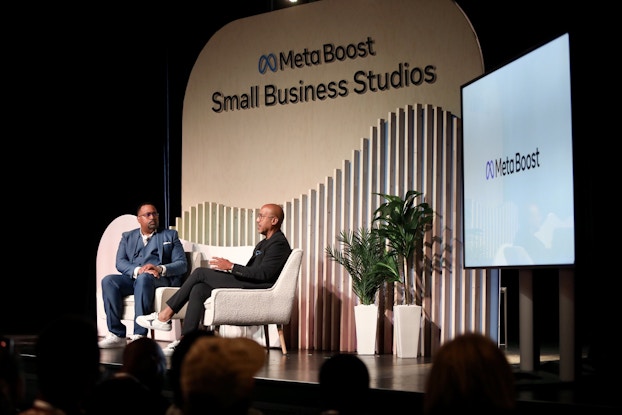  Two men on stage at a Meta Small Business Studios event.