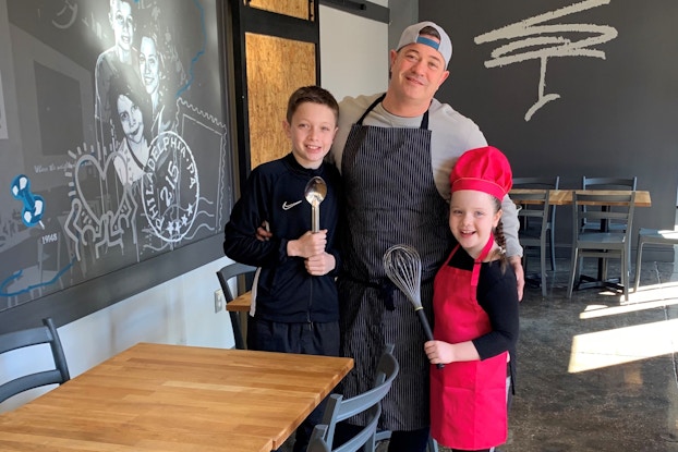 Miles Table restaurant owner and his children inside the restaurant.