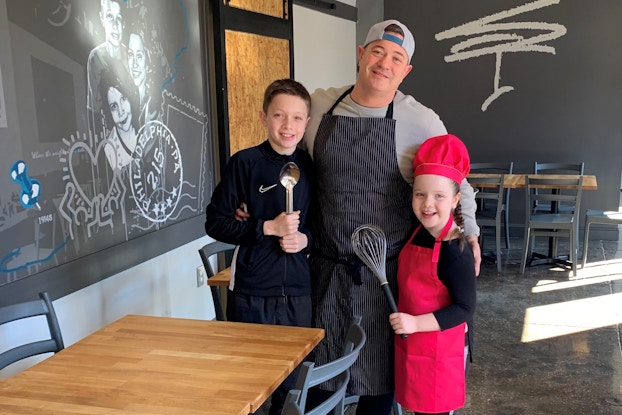  Miles Table restaurant owner and his children inside the restaurant.