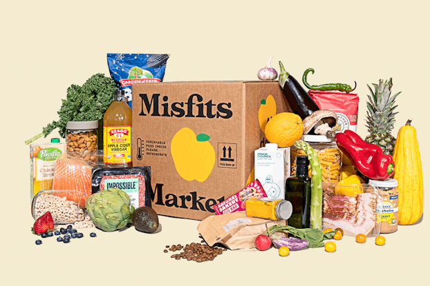  Misfits Market delivery box surrounded by produce and other food items the company sells.