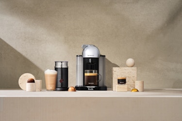 Nespresso machine on a countertop brewing coffee. 