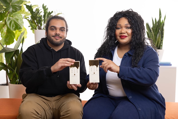  Headshot of Camille Bell and Johnny Velazquez, founders of Pound Cake, holding boxes of product.