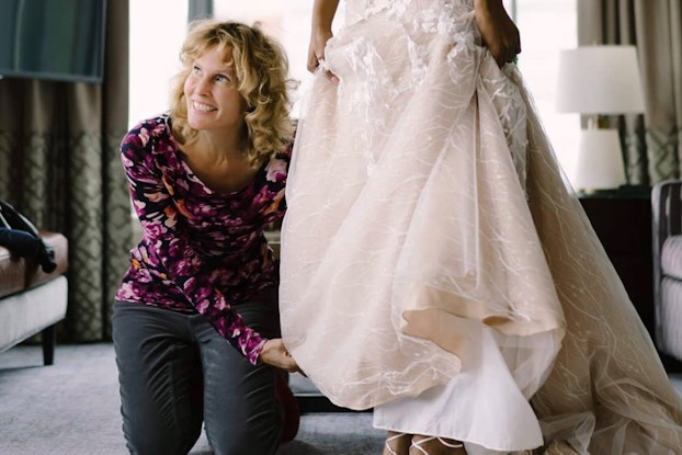 Luba Gankin of primavera dreams touching a wedding dress