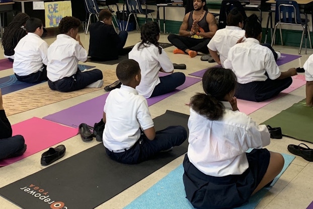 James Gaddy of Project Little Warriors teaching a yoga class of kids.