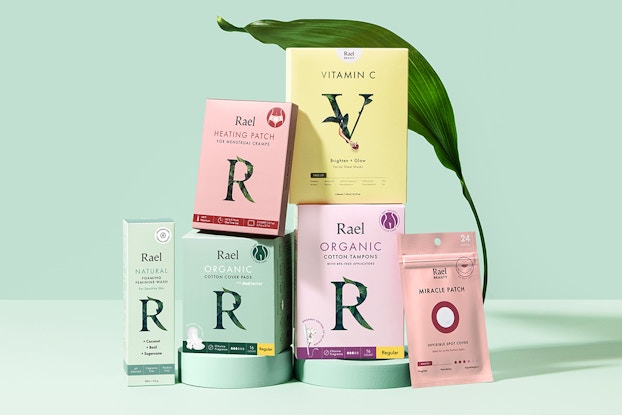 Product boxes by Rael in pastel colors with a mint green background.