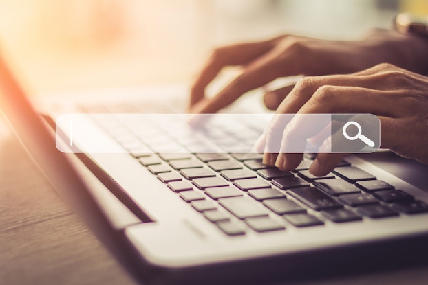 hands on keyboard with image of a search bar