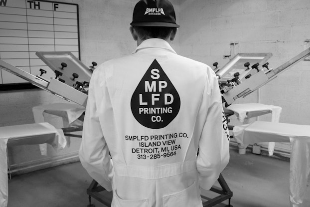  SMPLFD founder wearing his printing uniform inside the workplace.