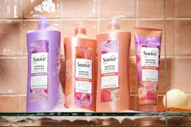 Bottles of the Suave Bonding Infusion product line pictured on a shower shelf.