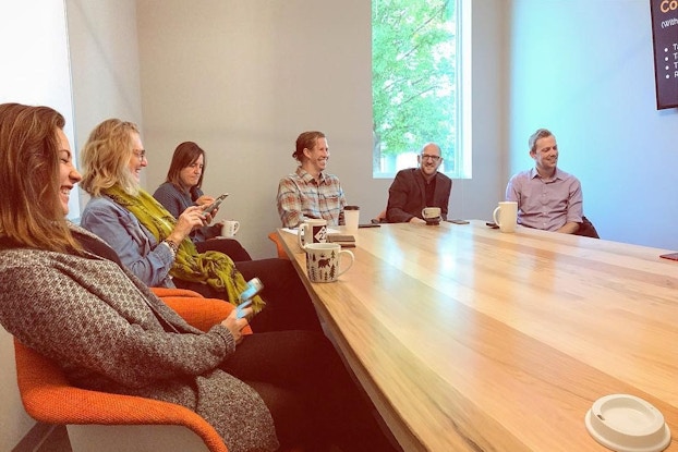 Smiling colleagues have an informal meeting in a conference room