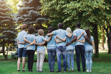 group of volunteers with their arms around each other