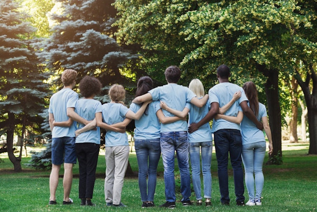  group of volunteers with their arms around each other