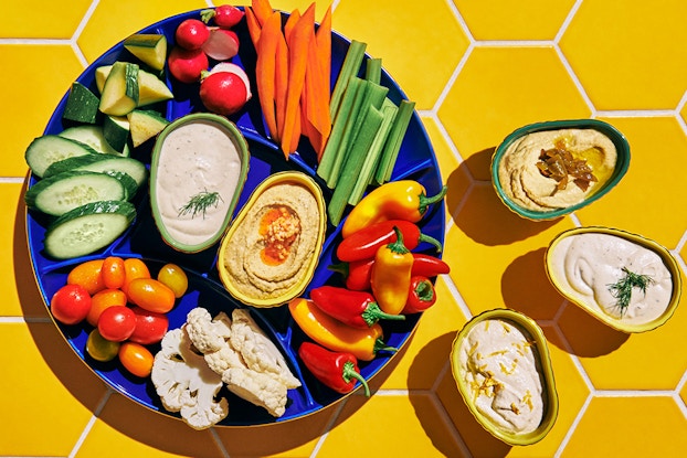 Vegetable platter and dip display with dishware from the Tabitha Brown for Target line.