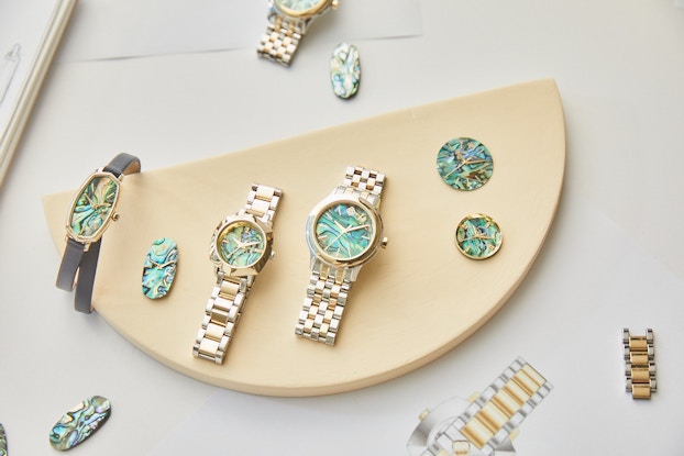  A collection of watches by Kendra Scott displayed on a tabletop.