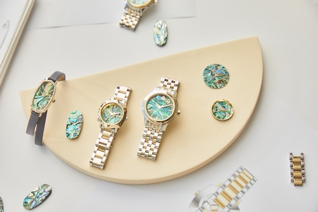 A collection of watches by Kendra Scott displayed on a tabletop.