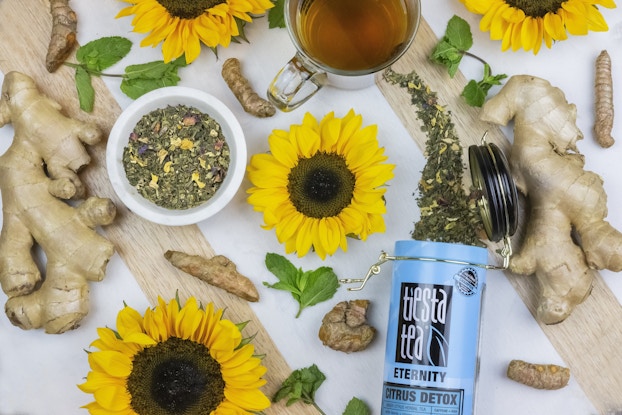 container of tiesta tea loose tea displayed with herbs and flowers