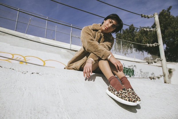  Model wearing Toms leopard shoes.