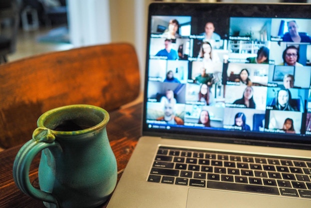 Laptop screen showing a virtual Triple Coffee coffee tasting next to a mug of coffee.
