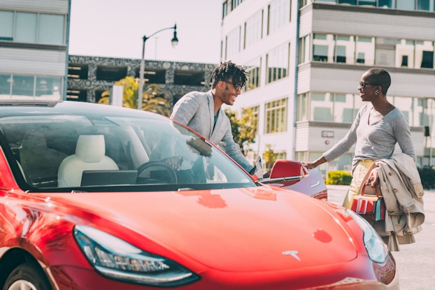  two people exchanging keys to share a car for turo