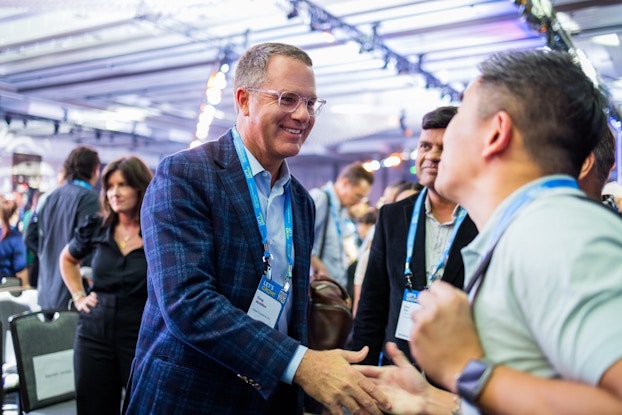 Walmart CEO Doug McMillon shakes hands with sellers at Walmart's first summit event.