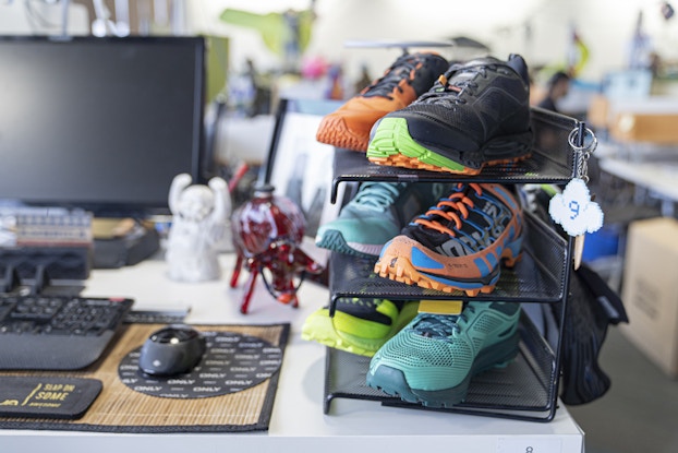 Employee desk at Zappos showing a sneaker display.