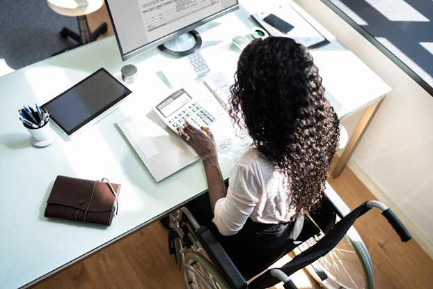 Woman working on accounting at her desk.