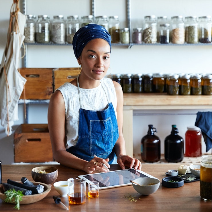 Small business owner standing inside her shop.