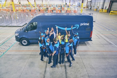  amazon employees in front of van 