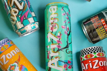  Colorful cans of AriZona Beverage Co.'s iced tea laid on a blue tabletop. 