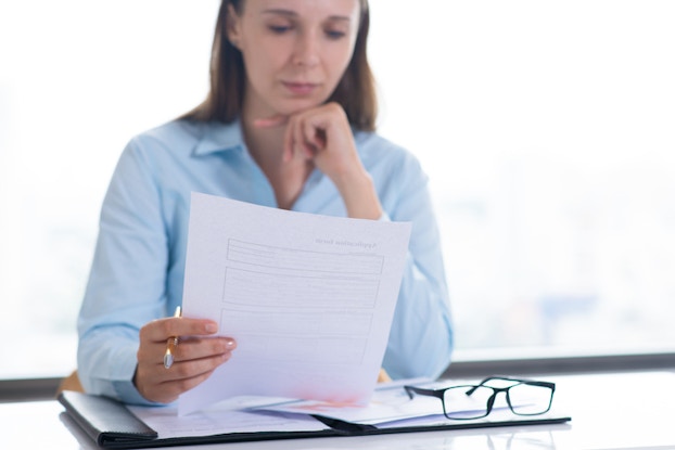  professional woman looking over a document