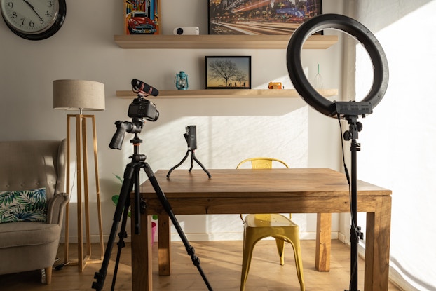  Home office setup for recording video, including a ring light and a camera.