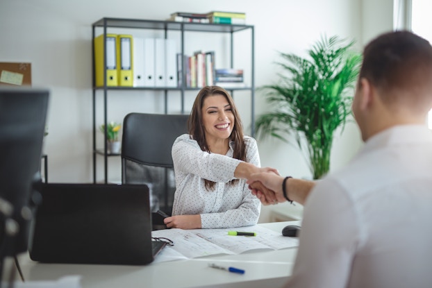  woman interviewing man in office