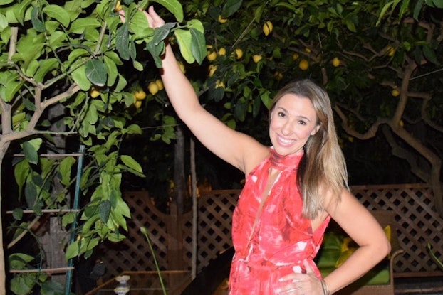 Kara Freedman, founder of Baked by Nature, pulling fruit from a tree.