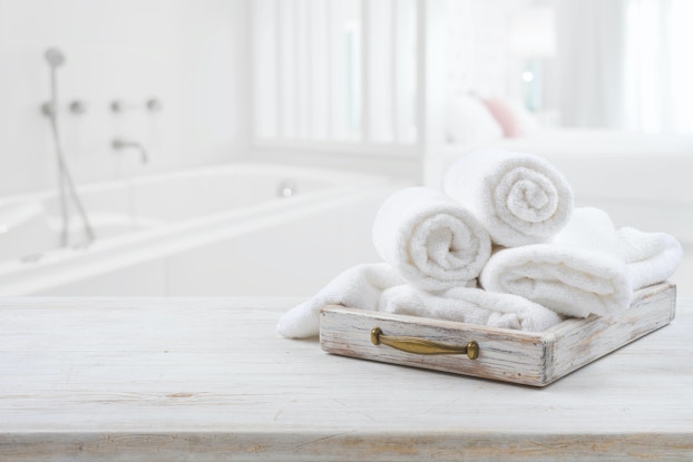 towels rolled up in white bathroom
