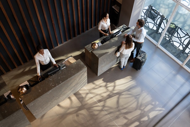 top view of couple checking into a hotel