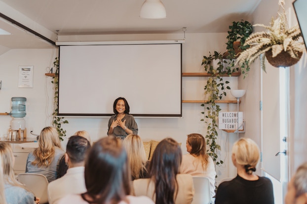 Jeanelle Teves, Chief Commercial Officer of Bugaboo, standing in front of a group during a team meeting.