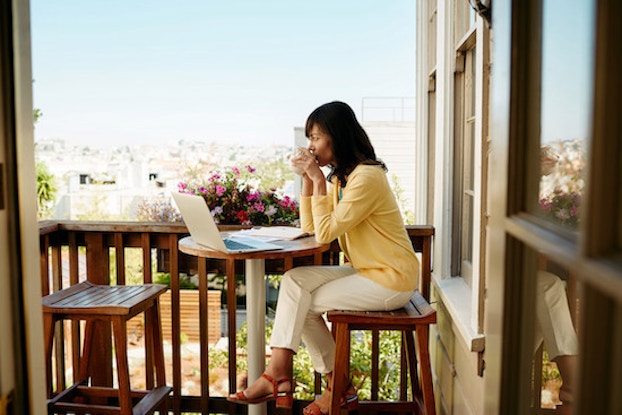  woman sitting outside with laptop