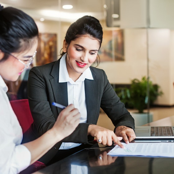 two women signing a contract