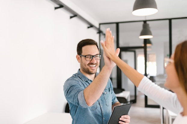 two colleagues high-fiving