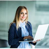 a woman holding a laptop