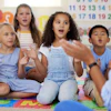 a group of children sitting on the floor