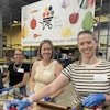 a group of women standing in a warehouse