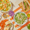 a table with plates of food and drinks