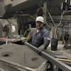 a man in a hard hat working in a factory