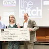 a group of people holding a large check