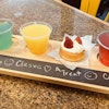a tray of drinks and desserts