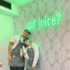 a man and woman holding bottles of juice