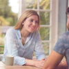 a man and woman sitting at a table